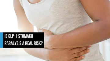Person holding stomach in discomfort.