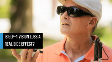 Older man wearing sunglasses and holding a white cane.