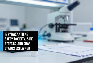 Pharmaceutical-grade crystalline powder in a glass vial on a lab surface beside a precision scale and safety report — representing paraxanthine's rigorous toxicology testing and GRAS-affirmed purity standards.