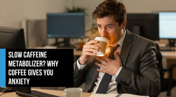 Young professional man at his desk gripping a coffee cup with visible tension and anxiety — illustrating overstimulation and nervous system strain from too much caffeine.