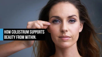 Woman with healthy glowing skin touching face showing colostrum beauty from within anti-aging support