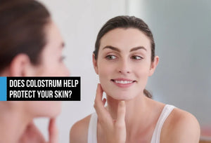 Woman examining healthy skin in mirror showing colostrum exosome support for skin protection and healthy aging