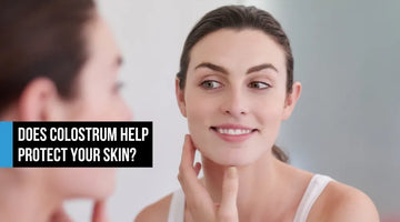 Woman examining healthy skin in mirror showing colostrum exosome support for skin protection and healthy aging