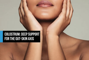 Close-up of a woman with clear glowing skin holding her face in her hands, with text overlay reading Colostrum Deep Support for the Gut-Skin Axis