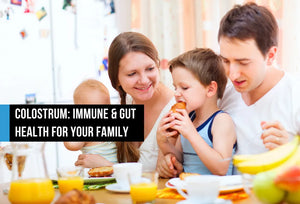 Family of four with two young children eating breakfast together at a table with orange juice and fruit, with text overlay reading Colostrum Immune and Gut Health for Your Family
