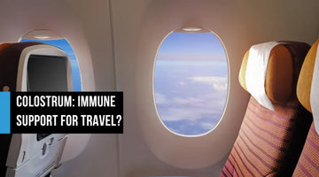 Empty airplane cabin seats with oval window showing blue sky and clouds, with text overlay reading Colostrum Immune Support for Travel?
