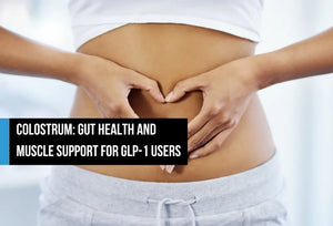 A woman forming a heart shape with her hands over her stomach, shown from the torso, with overlay text reading 'Colostrum: gut health and muscle support for GLP-1 users.'