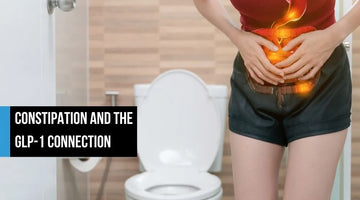 Woman holding abdomen with digestive discomfort.