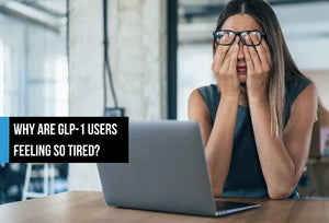 A tired woman sitting at a desk with a laptop, rubbing her eyes with both hands in a bright office, with overlay text reading 'Why are GLP-1 users feeling so tired?'