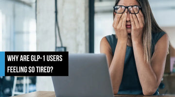 A tired woman sitting at a desk with a laptop, rubbing her eyes with both hands in a bright office, with overlay text reading 'Why are GLP-1 users feeling so tired?'