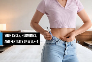 A woman holding a GLP-1 injection pen to her abdomen, shown from the torso in a bedroom, with overlay text reading 'Your cycle, hormones, and fertility on a GLP-1.'