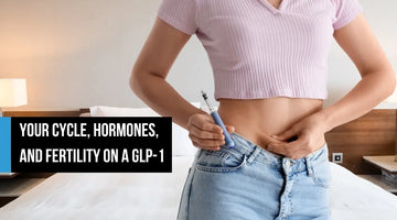 A woman holding a GLP-1 injection pen to her abdomen, shown from the torso in a bedroom, with overlay text reading 'Your cycle, hormones, and fertility on a GLP-1.'