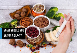 Overhead spread of nutrient-dense foods beside a GLP-1 pen.