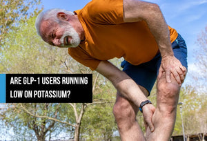 Older man outdoors holding his leg during a muscle cramp.