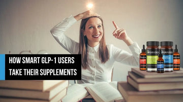 Woman sitting among books beside supplement bottles.