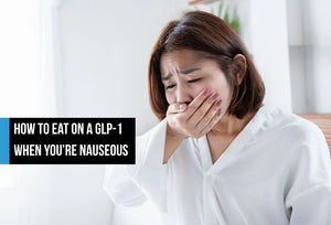 Woman covering mouth due to nausea.
