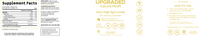 Upgraded Formulas® Upgraded Colostrum powder in a container on a wooden surface with a scoop beside it.
